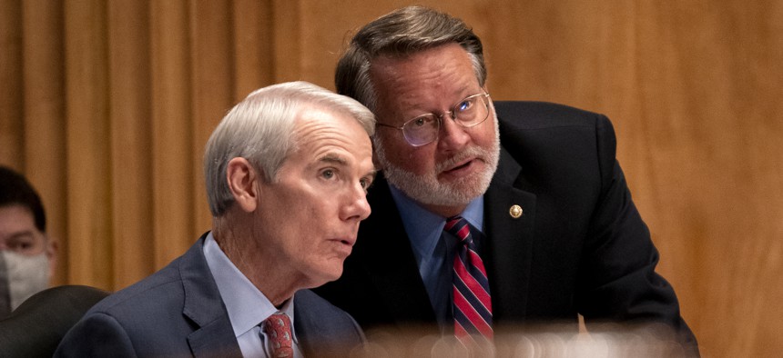 Sens. Rob Portman (R-OH) and Gary Peters (D-MI), shown here at a September 2021 hearing. (Photo by Greg Nash - Pool/Getty Images)
